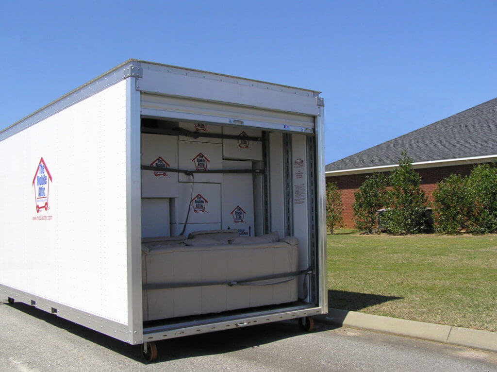 Loaded Mobile Attic Container beside brown house