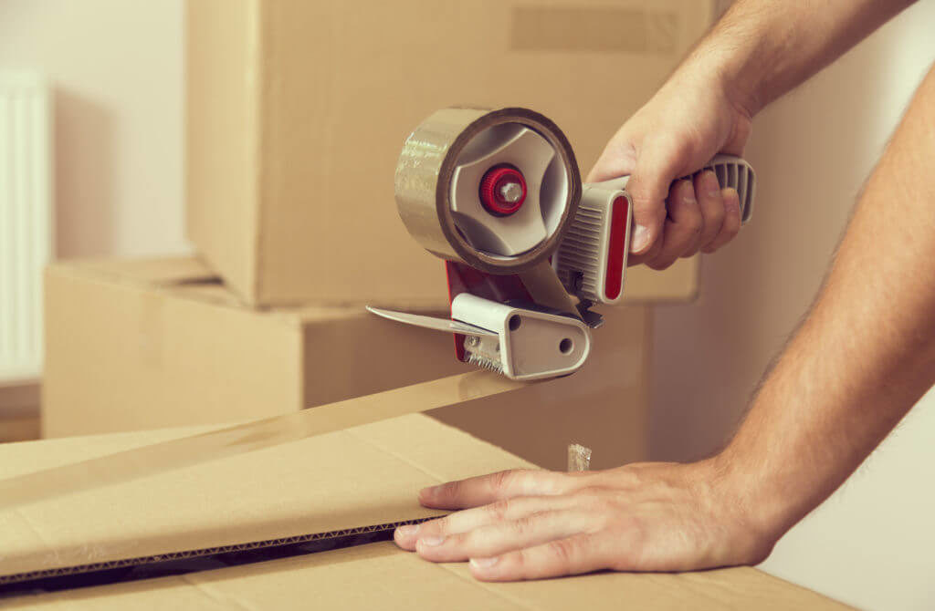 Man Taping A Box