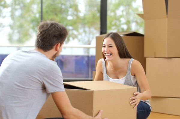 Man and woman Smiling with Boxes Mobile Attic Website Image