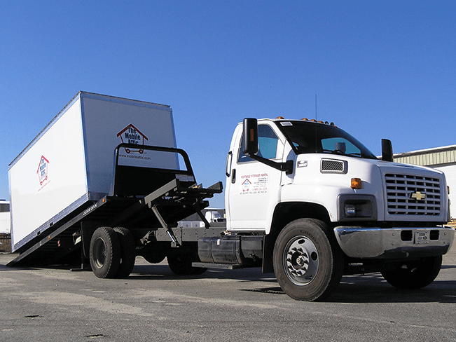 Mobile Attic Truck unloading container at lot