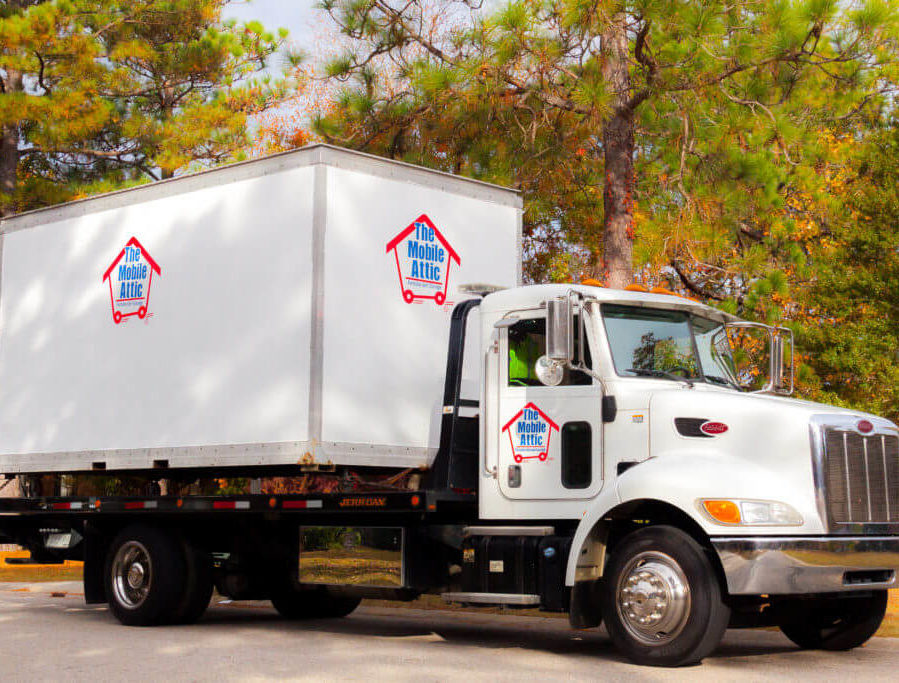 Mobile Attic Truck with green and orange trees On Site Self Storage Page