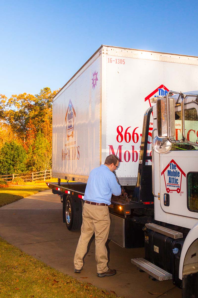 Man in white shirt loading boxes