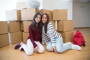 Two Women Moving with Storage Boxes