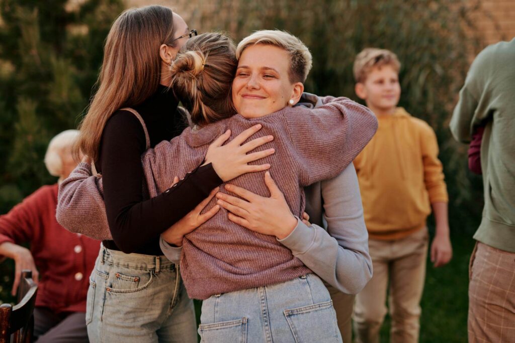 Neighbors Hugging Each other at New Home Image