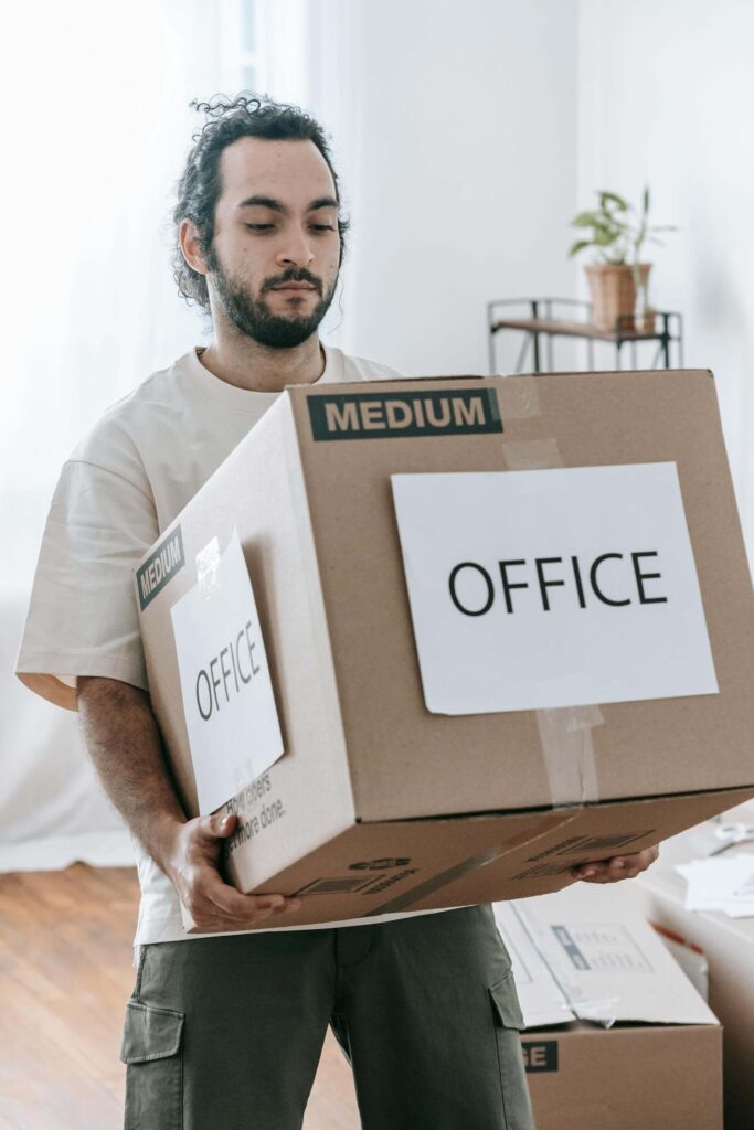 Man Holding Office Labeled Moving Box