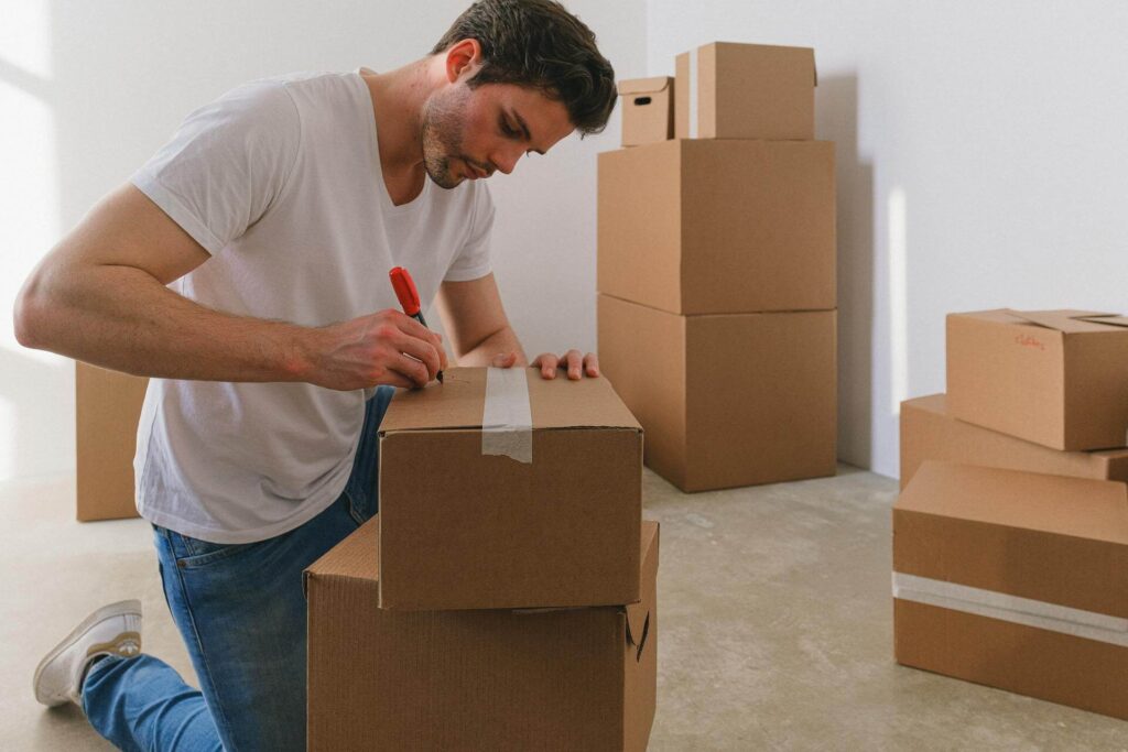 Man Writing Label for Moving Box