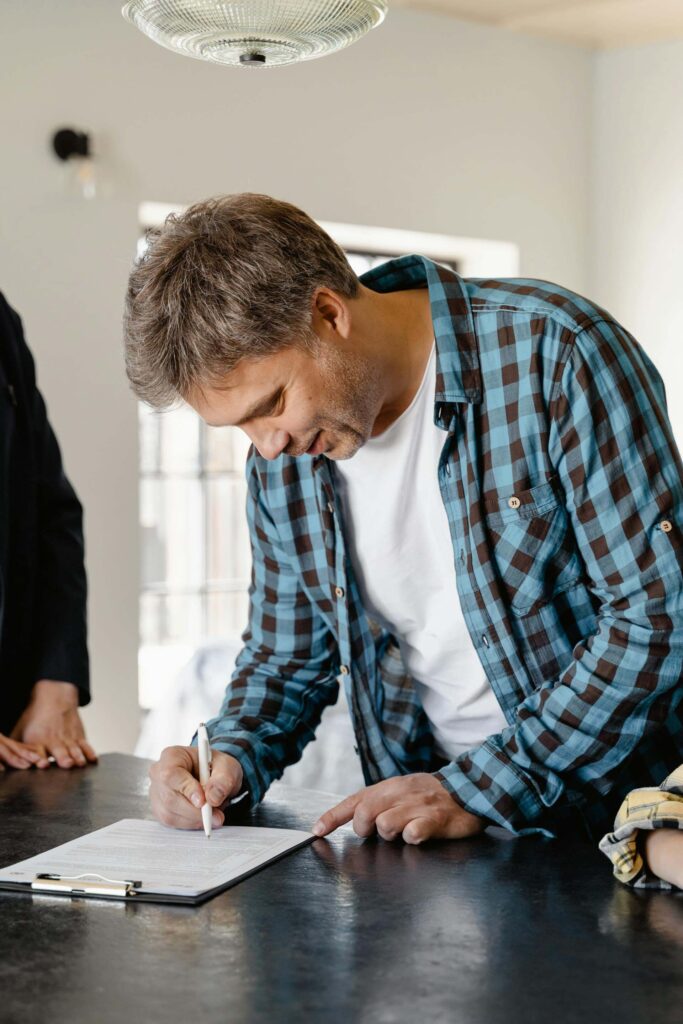 Man signing Moving Documents