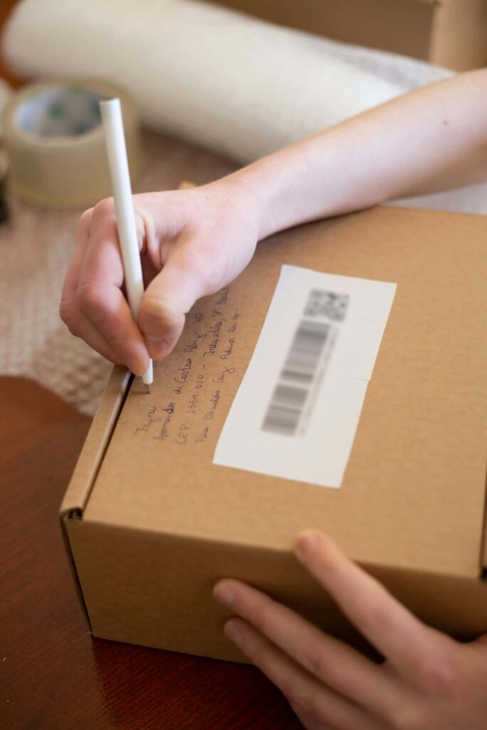Woman Writing Label for Moving Box
