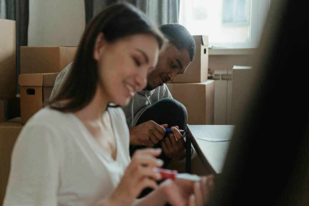 Couple using Screwdrivers with Boxes