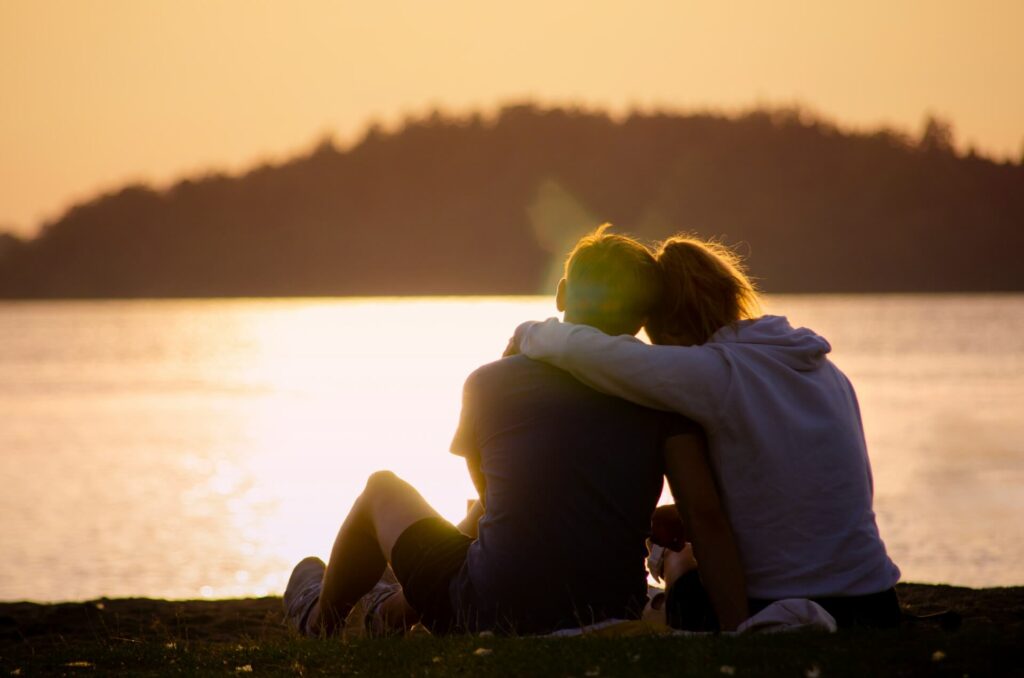 Man and Woman Hugging with Sunset on Lake Image